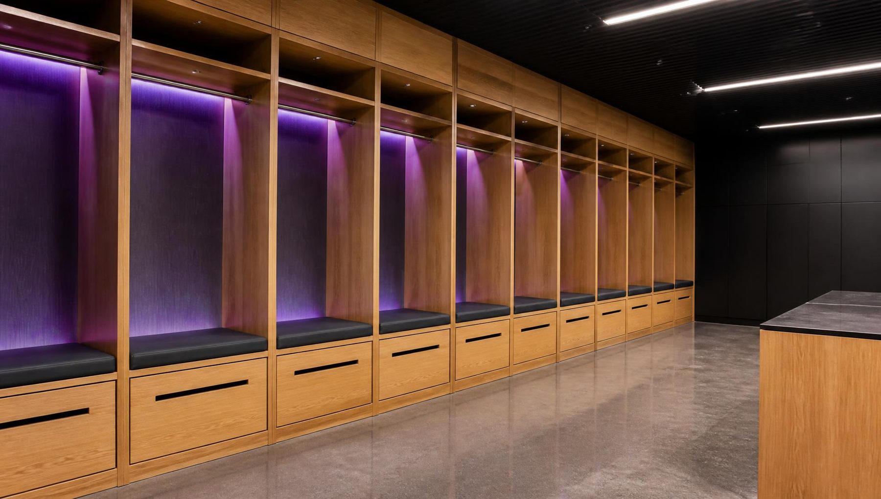 Illustrative render of the proposed athlete changing rooms with individual timber cubicles, benches and violet accent lighting